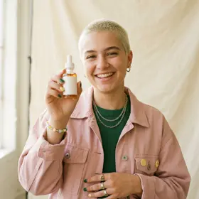 Creator holding up a skincare product